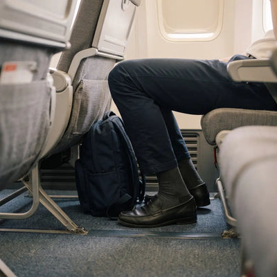 Traveler sitting with limited legroom during a long flight.